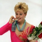 Elizabeth Manley biting the silver menu holding a bouquet of flowers